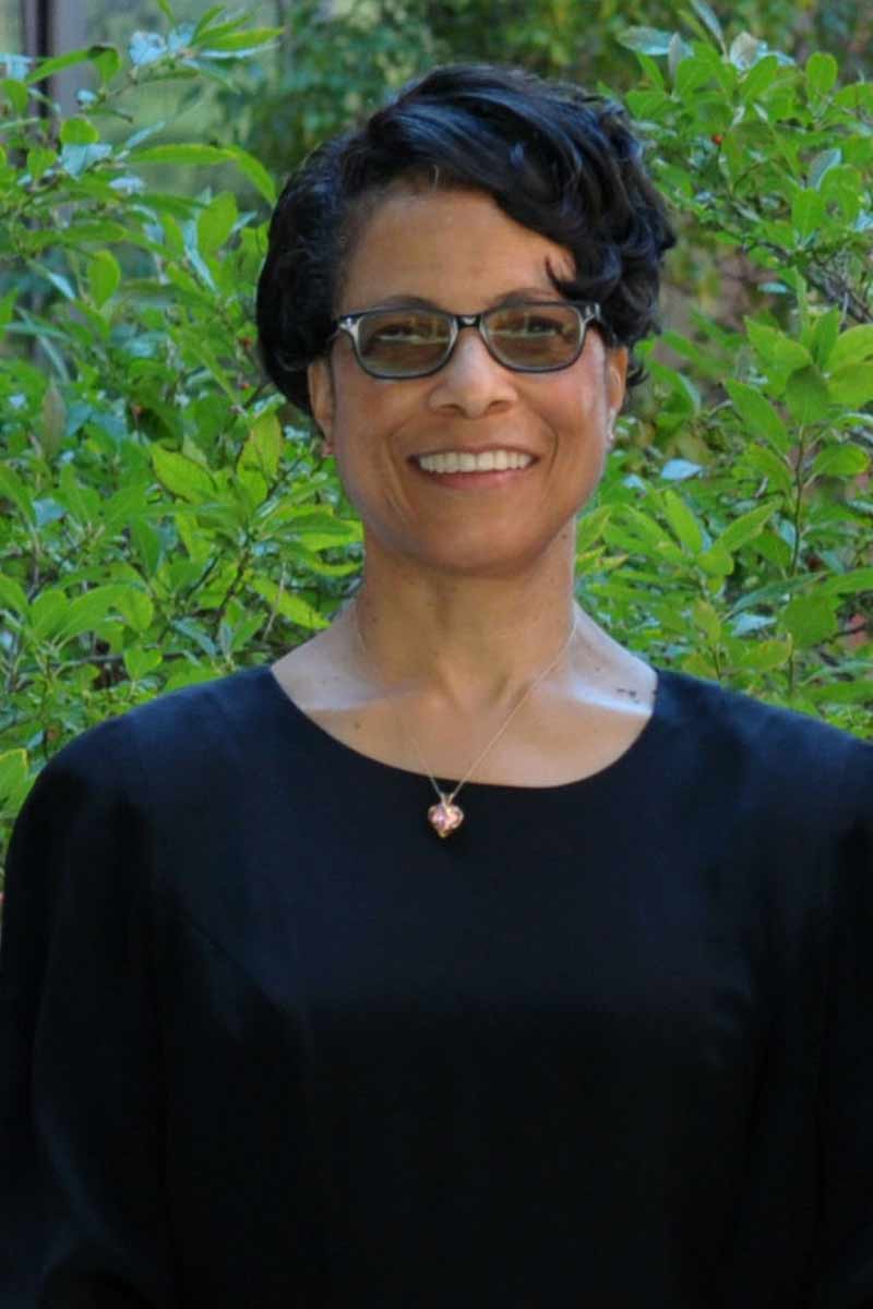 Barbara standing outside in a courtyard