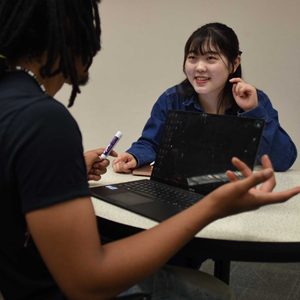 Two students discussing a topic in their own study group