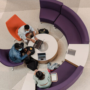 Students gathering around a table, deep in discussion