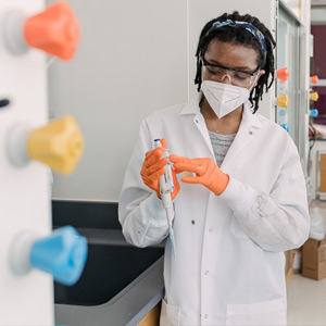 A young research student holding a test tube in a lab