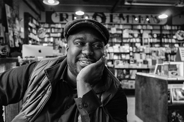 A picture of the author, smiling in a bookstore